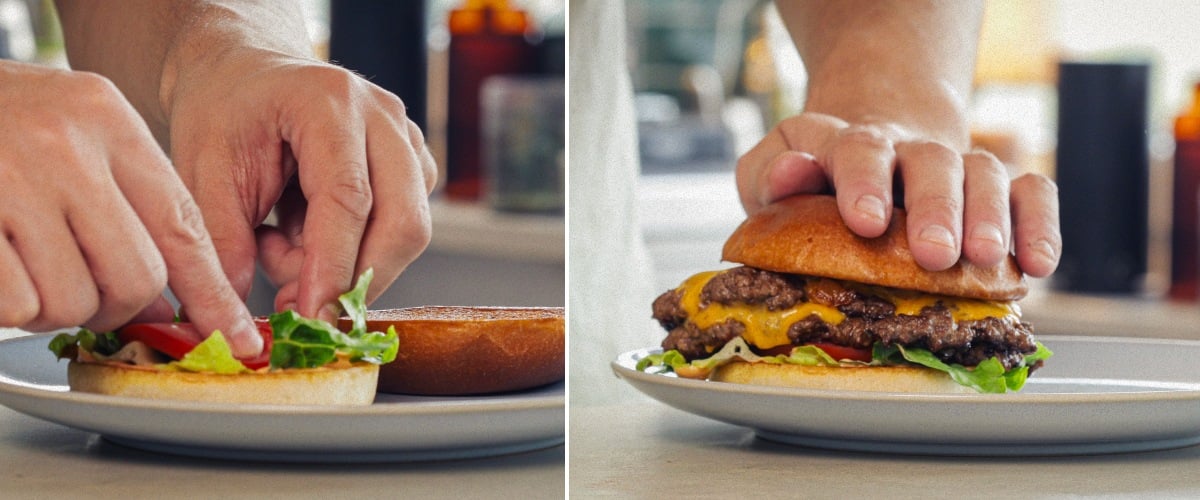 Fertiger Cannabis-Burger – Servierbereit mit infundiertem Brötchen und Cheddar Zusammenstellen und Servieren eines fertigen Cannabis-Burgers mit geschmolzenem Cheddar, Salat, Tomate und infundiertem Brötchen